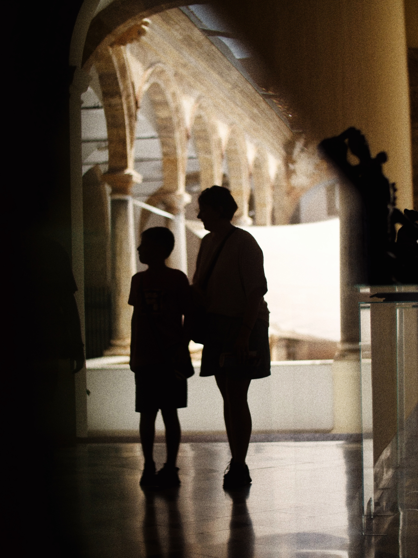 Silhouetten in een binnenplaats vol bogen